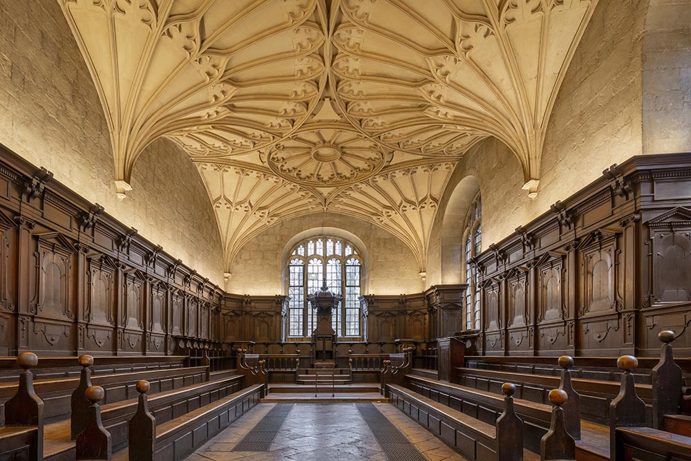 Convocation House A wood-panelled room with an elaborate fanned stone ceiling