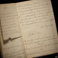 An open page of writing with a torn page