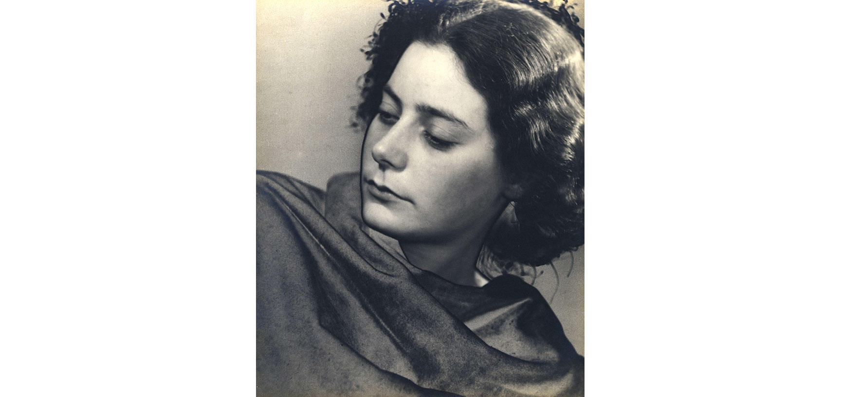Photograph of a woman looking over her right shoulder 