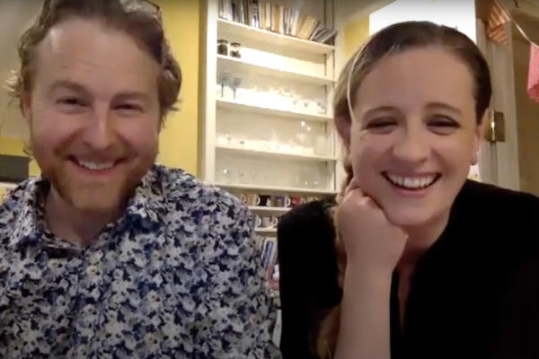 A man and a woman sitting next to each other on a Zoom call