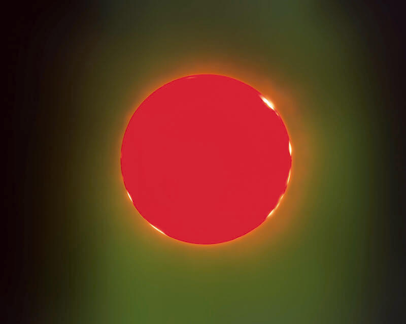 A circular region of bright red colour surrounded by lighter green and black