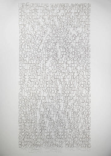 A photography of a tall sculpture made in wire. The wire make the shape of different words.